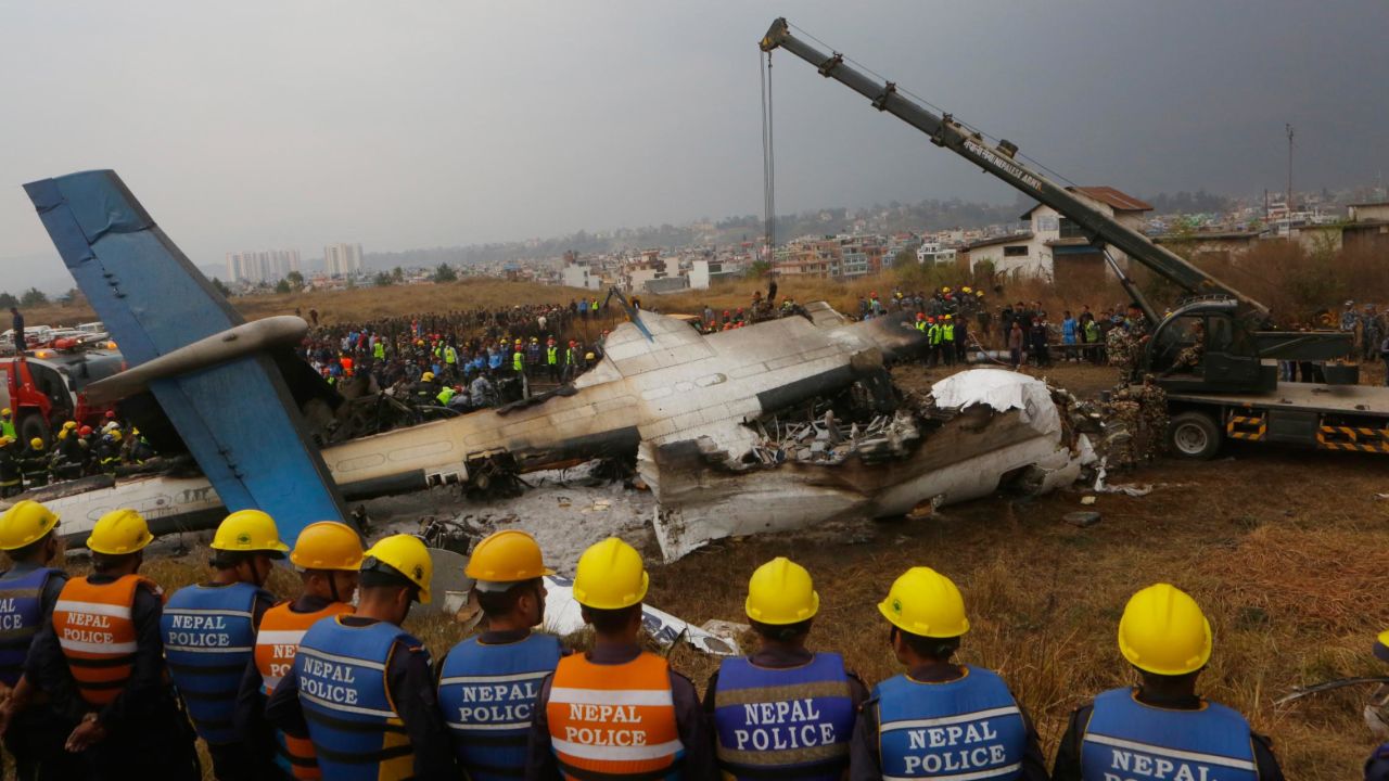 Rescuers gather around the crash site on March 12.