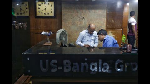 Staff from US-Bangla Airlines, a privately owned Bangladeshi carrier, work at an office in Dhaka, Bangladesh, on March 12. Flight BS 211 belongs to US-Bangla.