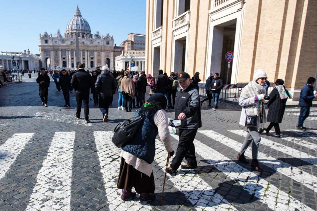 A woman begs for change in St. Peter's Square. The Pope chose the name Francis as a tribute to Saint Francis of Assisi, an Italian man who dedicated his life to the poor.