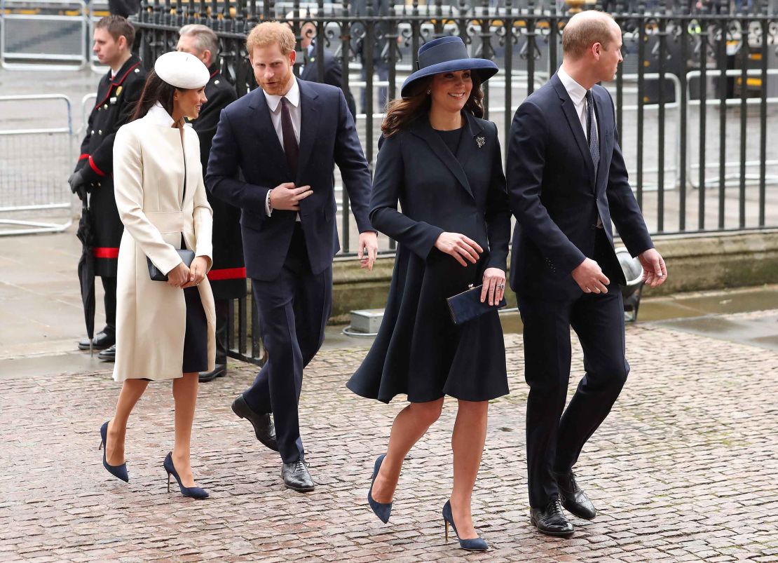 The Duchess of Cambridge (2R) and Prince William (R) arrive with Prince Harry (C) and Meghan Markle on Monday.