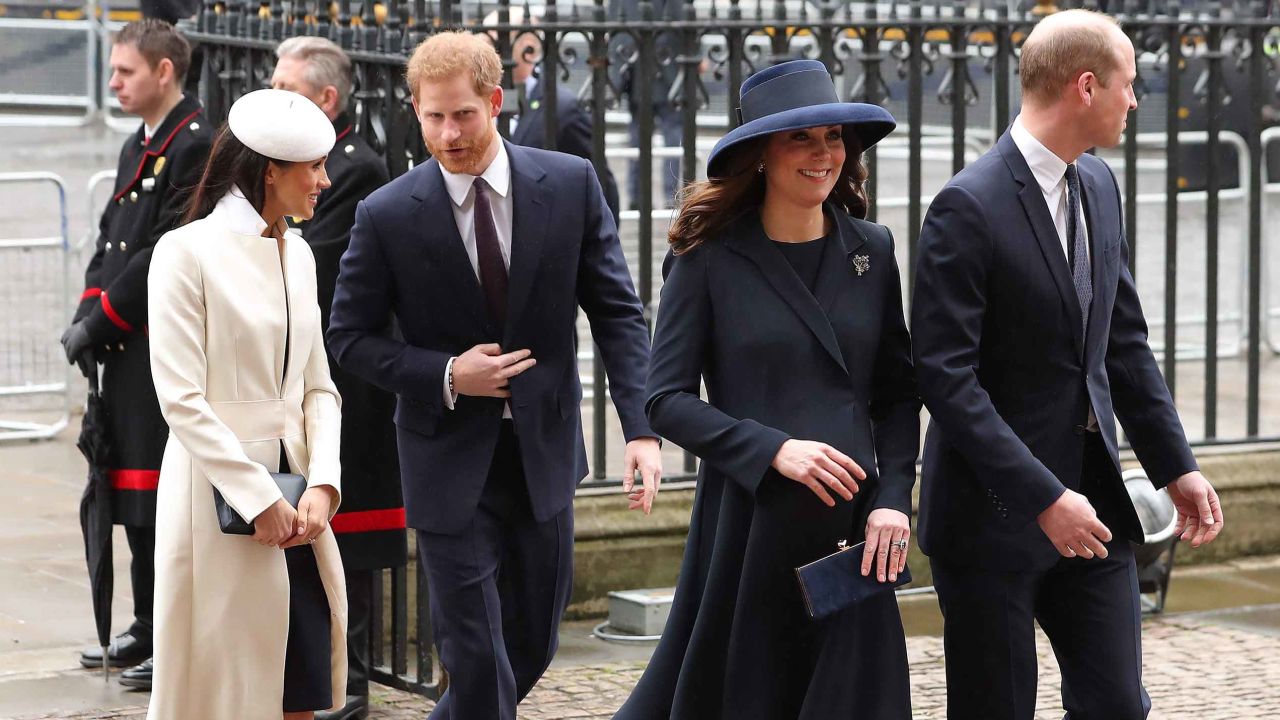 The Duchess of Cambridge (2R) and Prince William (R) arrive with Prince Harry (C) and Meghan Markle on Monday.