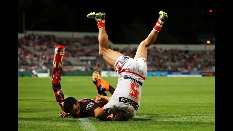 Jason Nightingale, right, scores a try for the St. George Illawarra Dragons during a National Rugby League match in Sydney on Thursday, March 8. The Dragons defeated the Brisbane Broncos 34-12 in their first match of the season.