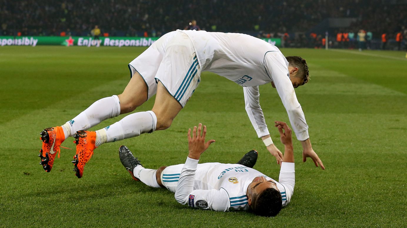 Cristiano Ronaldo jumps onto Real Madrid teammate Casemiro as they celebrate a Champions League goal in Paris on Tuesday, March 6. Madrid defeated Paris Saint-Germain 5-2 on aggregate to advance to the quarterfinals.