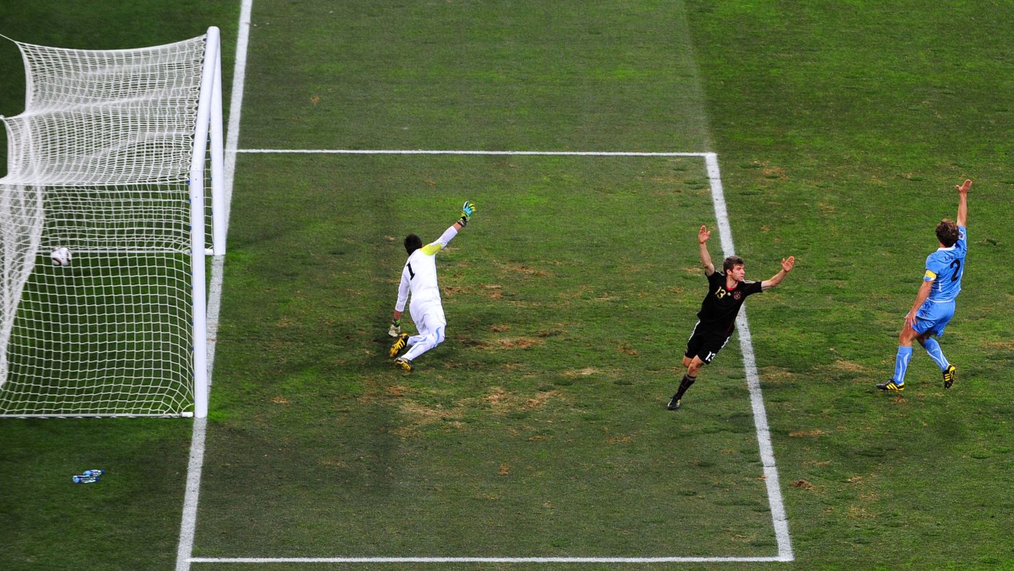 PORT ELIZABETH, SOUTH AFRICA - JULY 10:  Thomas Mueller of Germany celebrates scoring the opening goal past Fernando Muslera of Uruguay during the 2010 FIFA World Cup South Africa Third Place Play-off match between Uruguay and Germany at The Nelson Mandela Bay Stadium on July 10, 2010 in Port Elizabeth, South Africa.  (Photo by Jamie McDonald/Getty Images)