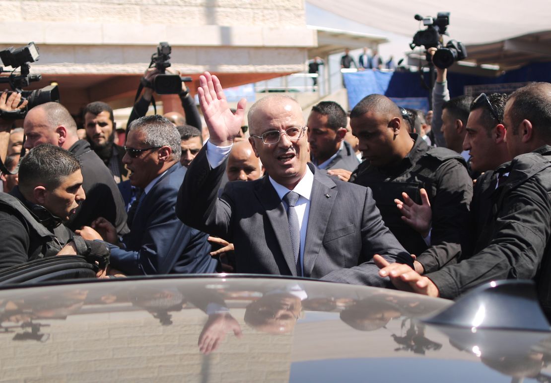 Hamdallah waves to crowds upon his arrival in Gaza City on Tuesday.
