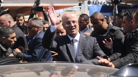 Hamdallah waves to crowds upon his arrival in Gaza City on Tuesday.