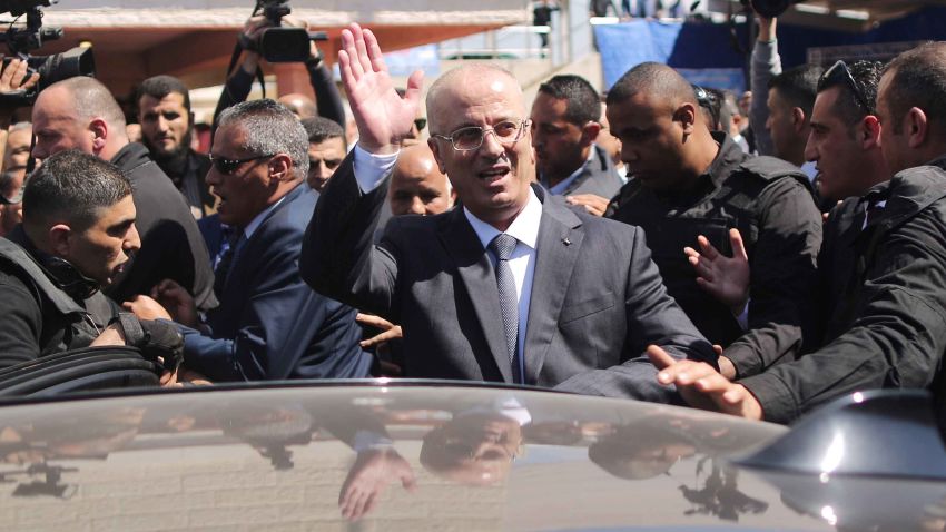 Palestinian Prime Minister Rami Hamdallah waves to the crowd upon his arrival in Gaza City on March 13, 2018.
Hamdallah cut short a rare visit to Gaza on Tuesday after an explosion targeted his convoy, a source in the delegation said. The premier, who was not hurt, left the Hamas-run territory through the Erez crossing shortly after opening a wastewater treatment facility, the source said. 
 / AFP PHOTO / MAHMUD HAMS / The erroneous mention[s] appearing in the metadata of this photo by MAHMUD HAMS has been modified in AFP systems in the following manner: [Hamdallah waves to the crowd upon his arrival] instead of [Hamdallah (2nd-R) is greeted by Hamas' security chief Tawfiq Abu Naim (C) upon his arrival ]. Please immediately remove the erroneous mention[s] from all your online services and delete it (them) from your servers. If you have been authorized by AFP to distribute it (them) to third parties, please ensure that the same actions are carried out by them. Failure to promptly comply with these instructions will entail liability on your part for any continued or post notification usage. Therefore we thank you very much for all your attention and prompt action. We are sorry for the inconvenience this notification may cause and remain at your disposal for any further information you may require.        (Photo credit should read MAHMUD HAMS/AFP/Getty Images)
