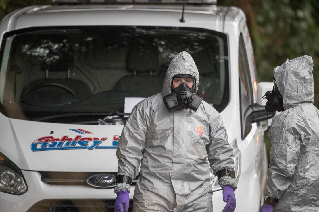 Investigators in protective clothing remove a van from an address in Winterslow near Salisbury.