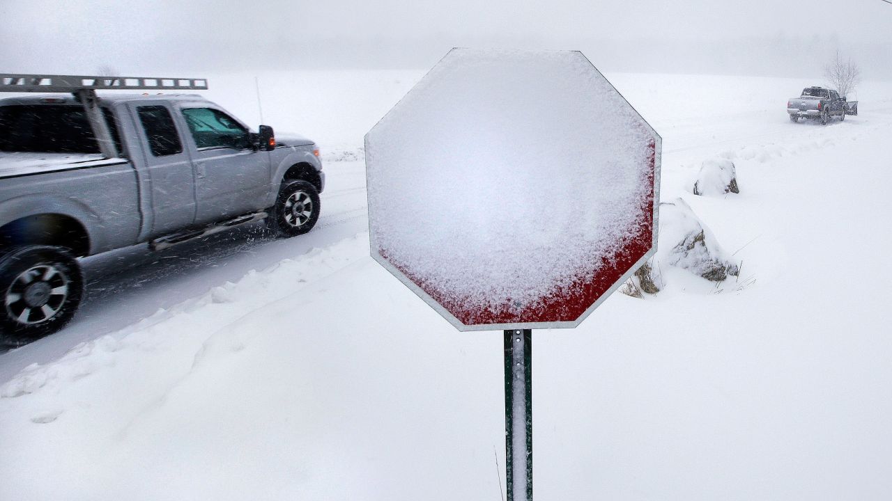 Wind-blown snow covers a stop sign in Derry, New Hampshire, on March 13.