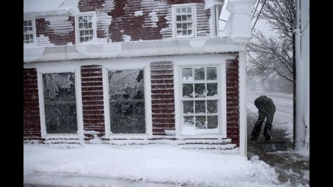 Cole Stiles clears a sidewalk in Scituate, Massachusetts, on March 13.