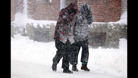 Heavy snow falls on two pedestrians in New Bedford, Massachusetts, on March 13.
