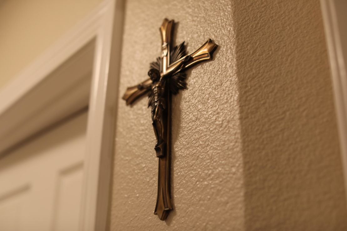Two crosses on the wall are the sparse decorations in the apartment.