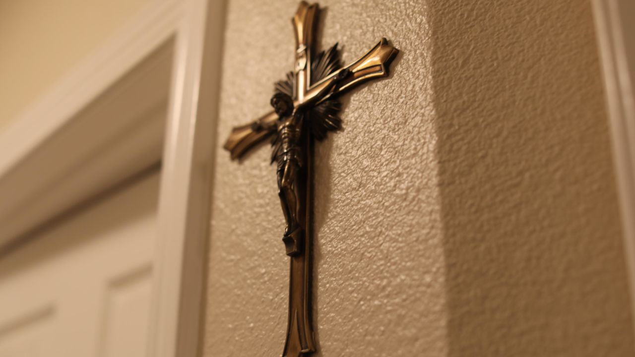 Two crosses on the wall are the sparse decorations in the apartment.