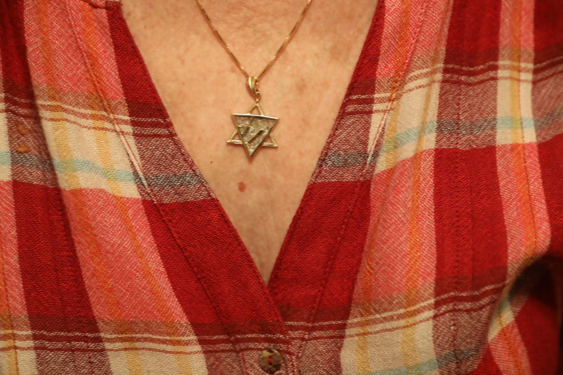 The woman wears a Star of David pendant. To her, the Holocaust is a permanent reminder that people could be kicked out of a country they thought was home.