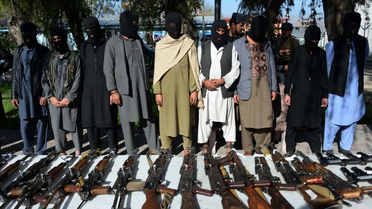 Alleged Taliban fighters and other militants stand handcuffed while being presented to the media at a police headquarters in Jalalabad on March 6, 2018. 
Afghan police said over 17 alleged Taliban militants including two Pakistani nationals were arrested during a five-week operation in Nangarhar province. / AFP PHOTO / NOORULLAH SHIRZADA        (Photo credit should read NOORULLAH SHIRZADA/AFP/Getty Images)