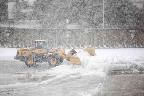 A snow plow clears a taxiway at Logan International Airport in Boston.