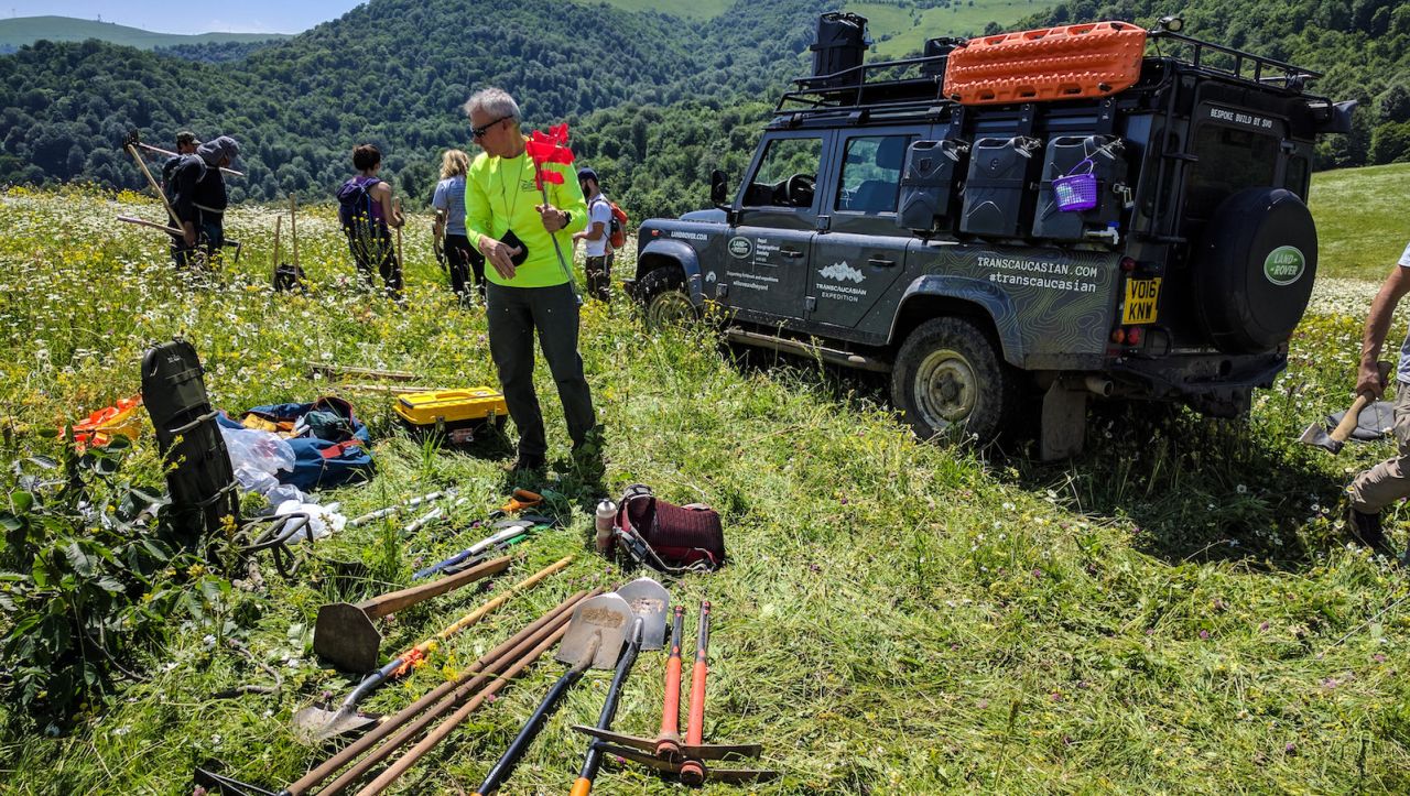 The team prepares their tools for another day of work on a trail section.
