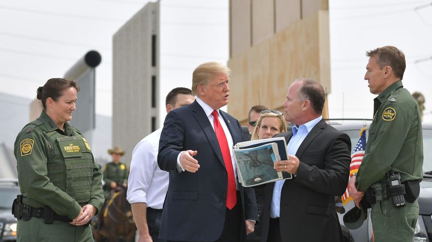 US President Donald Trump (C) is shown border wall prototypes in San Diego, California on March 13, 2018. / AFP PHOTO / MANDEL NGAN        (Photo credit should read MANDEL NGAN/AFP/Getty Images)