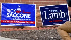 A cameraman takes footage of the signs for the two candidates outside a polling place in the special election being held for the PA 18th Congressional District vacated by Republican Tim Murphy, Tuesday, March 13, 2018, in McKeesport, Pa. Republican Rick Saccone had just voted at the site. Saccone is running against Democrat Conor Lamb. (AP Photo/Keith Srakocic)