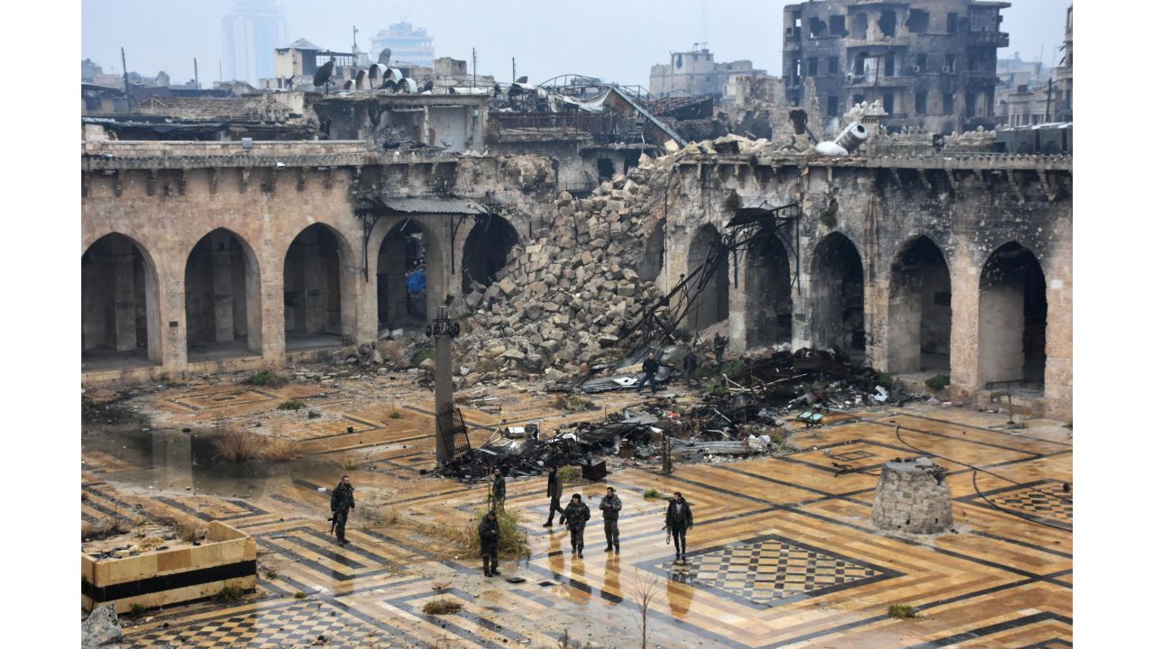  Syrian pro-government forces walking in the ancient Umayyad mosque in the old city of Aleppo after they captured the area. 