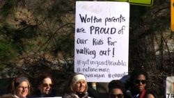 NS Slug: GA:NATL WALKOUT-WALTON HS PARENTS HOLD SIGNS  Synopsis: Cobb County students walk out despite disciplinary threats  Keywords: GEORGIA COBB COUNTY HIGH SCHOOL