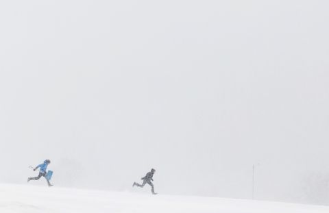 People run through heavy snow in Portland, Maine, on March 13.