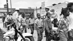 Policemen leading a group of black school children into jail, following their arrest for protesting against racial discrimination near the city hall of  Birmingham, Ala., on May 4, 1963. (AP Photo/Bill Hudson)