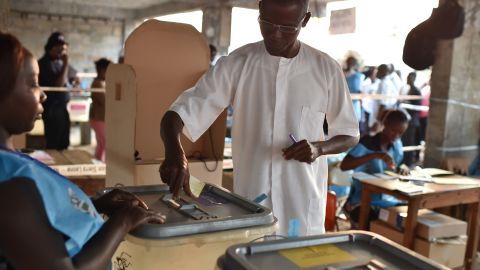 A man casts his ballot in the general elections on March 7, 2018 at a polling station in Freetown. 
