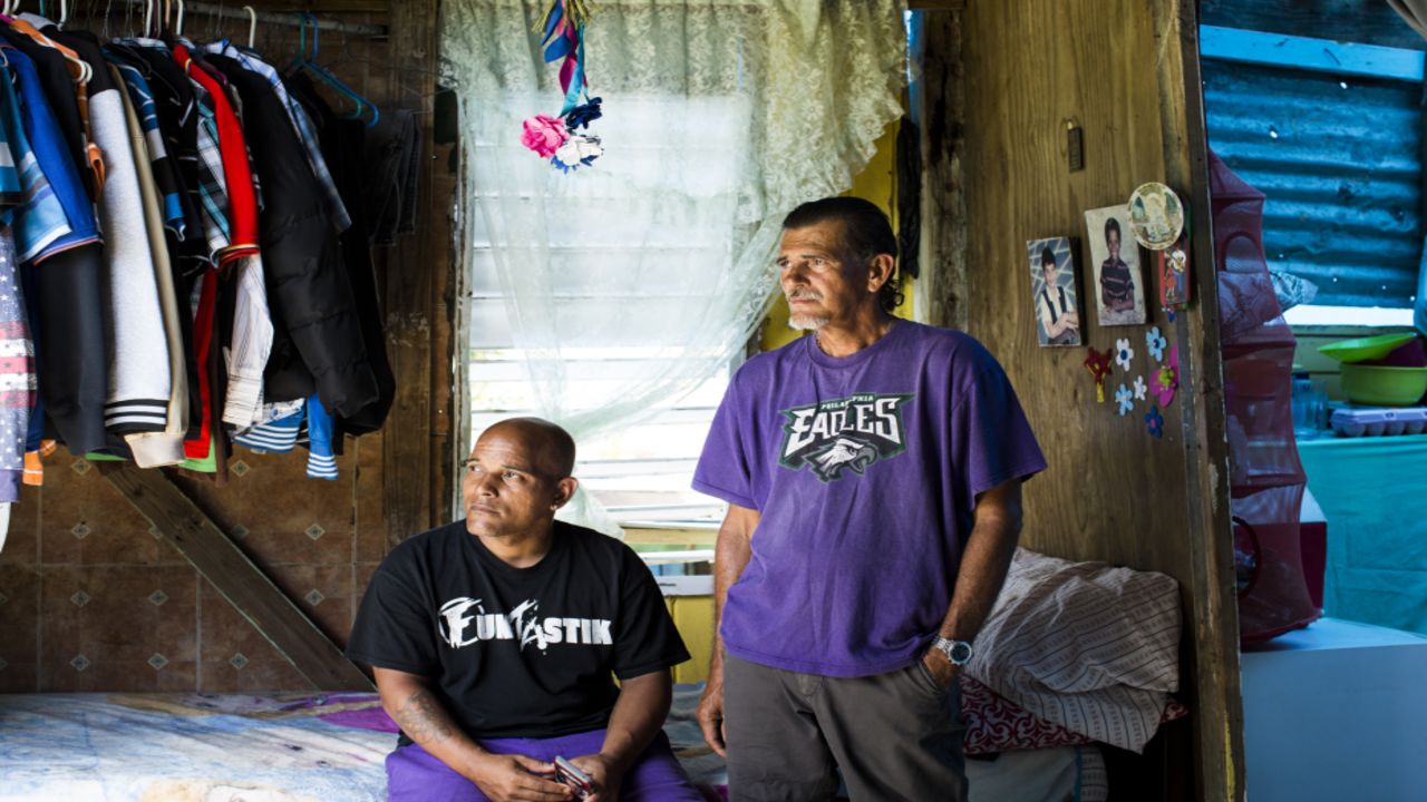 Héctor Pedraza, left, lost his mother -- Herminio Trinidad's wife -- when she died in February in the aftermath of Maria.