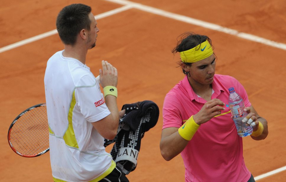 Federer didn't have to beat clay giant Rafael Nadal (right) that fortnight, as the Spaniard lost to Robin Soderling in the fourth round. 