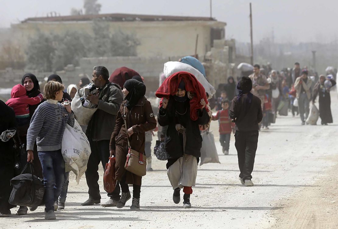 Syrians from Eastern Ghouta arrive at a regime-held checkpoint on the edge of Damascus. 