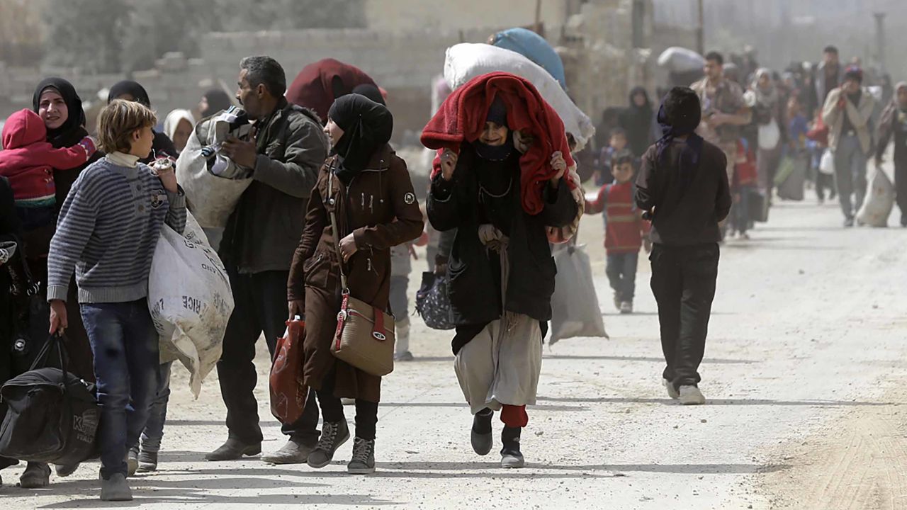 Syrians from Eastern Ghouta arrive at a regime-held checkpoint on the edge of Damascus.