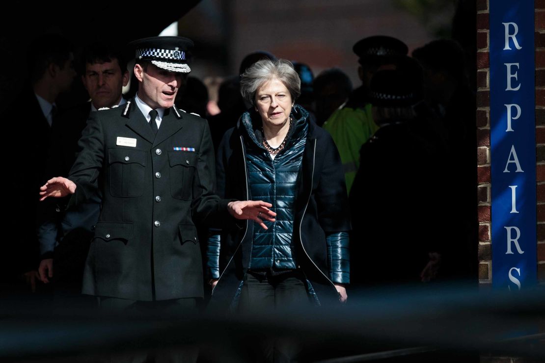 Police official Kier Pritchard and British Prime Minister Theresa May view the crime scene in Salisbury.