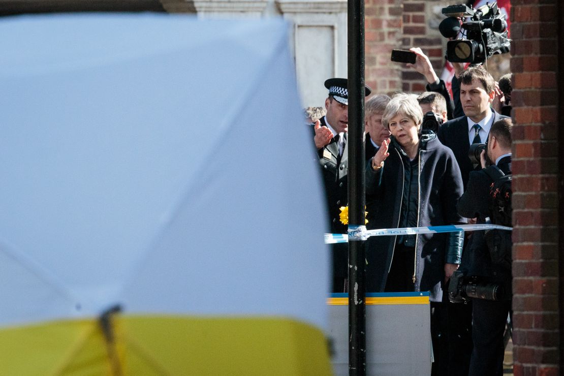 British Prime Minister Theresa May, center, on Thursday, March 15, 2018, visits the location in Salisbury, England, where Sergei Skripal and his daughter Yulia were discovered.