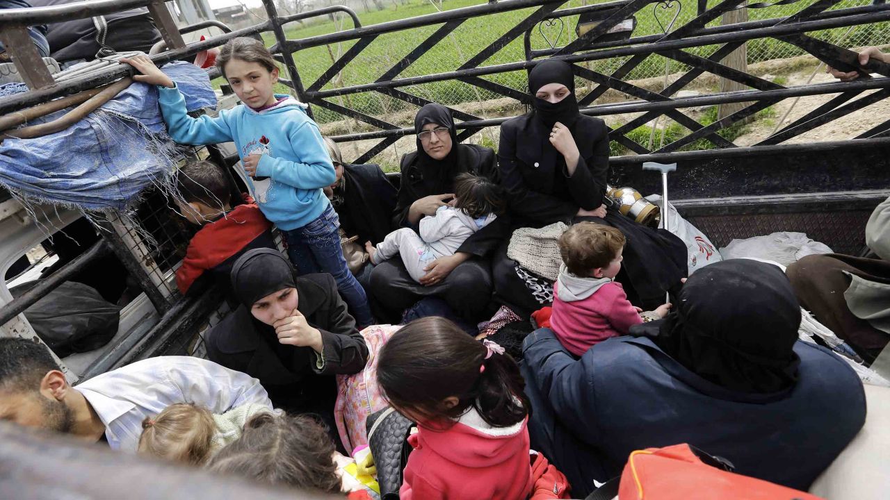 Syrians from rebel-held Eastern Ghouta arrive at the regime-held checkpoint in Adra, on the northeastern outskirts of Damascus, after escaping the enclave through a corridor opened by the government forces on March 15, 2018. 
Thousands of civilians poured out of Syria's Eastern Ghouta bringing the government closer to retaking the rebel enclave near the capital as the brutal war enters its eighth year.  / AFP PHOTO / LOUAI BESHARA        (Photo credit should read LOUAI BESHARA/AFP/Getty Images)