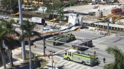 Emergency personnel responds to a collapsed pedestrian bridge connecting Florida International University Florida International on Thursday, March 15, 2018 in the Miami area.