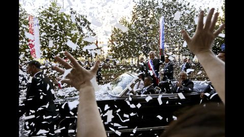 Chilean President Sebastian Piñera waves from a car as he makes his way to his inauguration on Sunday, March 11.
