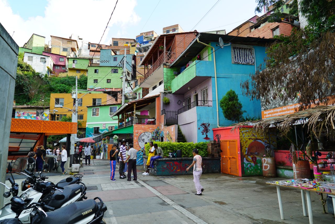 Colorful houses and food stalls line the Medellín streets.