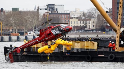 A crane lifts a helicopter from the East River in New York on Monday, March 12. Five people were killed Sunday night when the helicopter <a href="https://www.cnn.com/2018/03/12/us/victims-new-york-helicopter-crash/index.html" target="_blank">crash-landed in the river.</a>