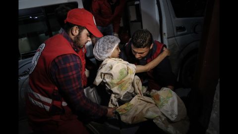 A young woman is transported by members of the Syrian Arab Red Crescent during evacuations from Douma to Damascus on Wednesday, March 14. <a href="https://www.cnn.com/2018/03/15/middleeast/eastern-ghouta-civilians-flee-exodus-intl/index.html" target="_blank">Thousands of people have fled</a> the besieged area of Eastern Ghouta as Syrian forces advance into the rebel-held enclave. <a href="https://www.cnn.com/interactive/2018/03/world/syria-eastern-ghouta-cnnphotos/index.html" target="_blank">More photos: Witnessing horror in Eastern Ghouta</a>