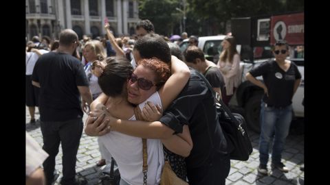 People console each other in front of Rio de Janeiro's City Hall as they pay their respects to city councilwoman Marielle Franco, who was gunned down while sitting in a car on Wednesday, March 14. Franco was 38.