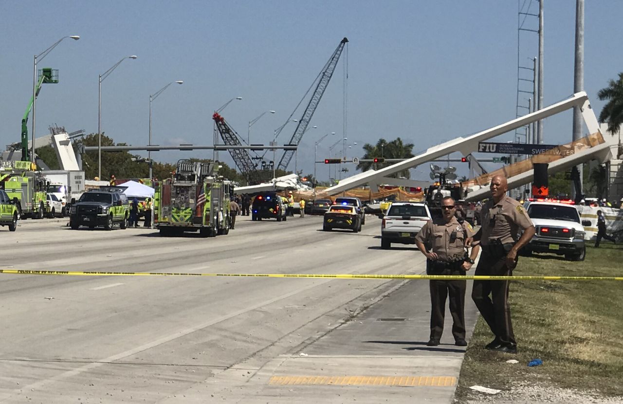 Police block a road near the collapsed bridge.