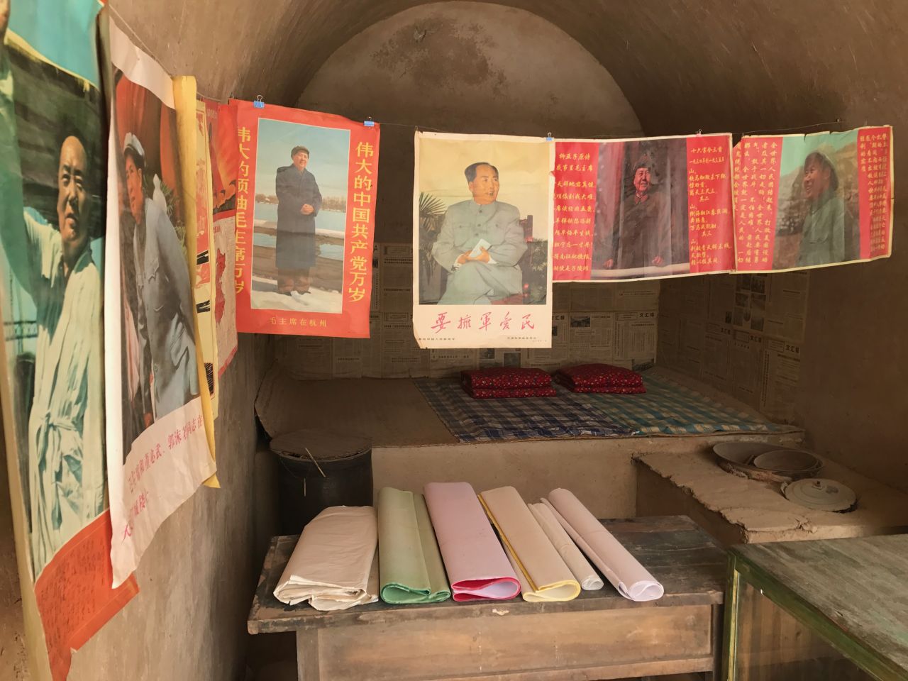 Posters of Mao Zedong and other reproduced Cultural Revolution-era articles are on display in several "cave houses" that Xi lived in the village.