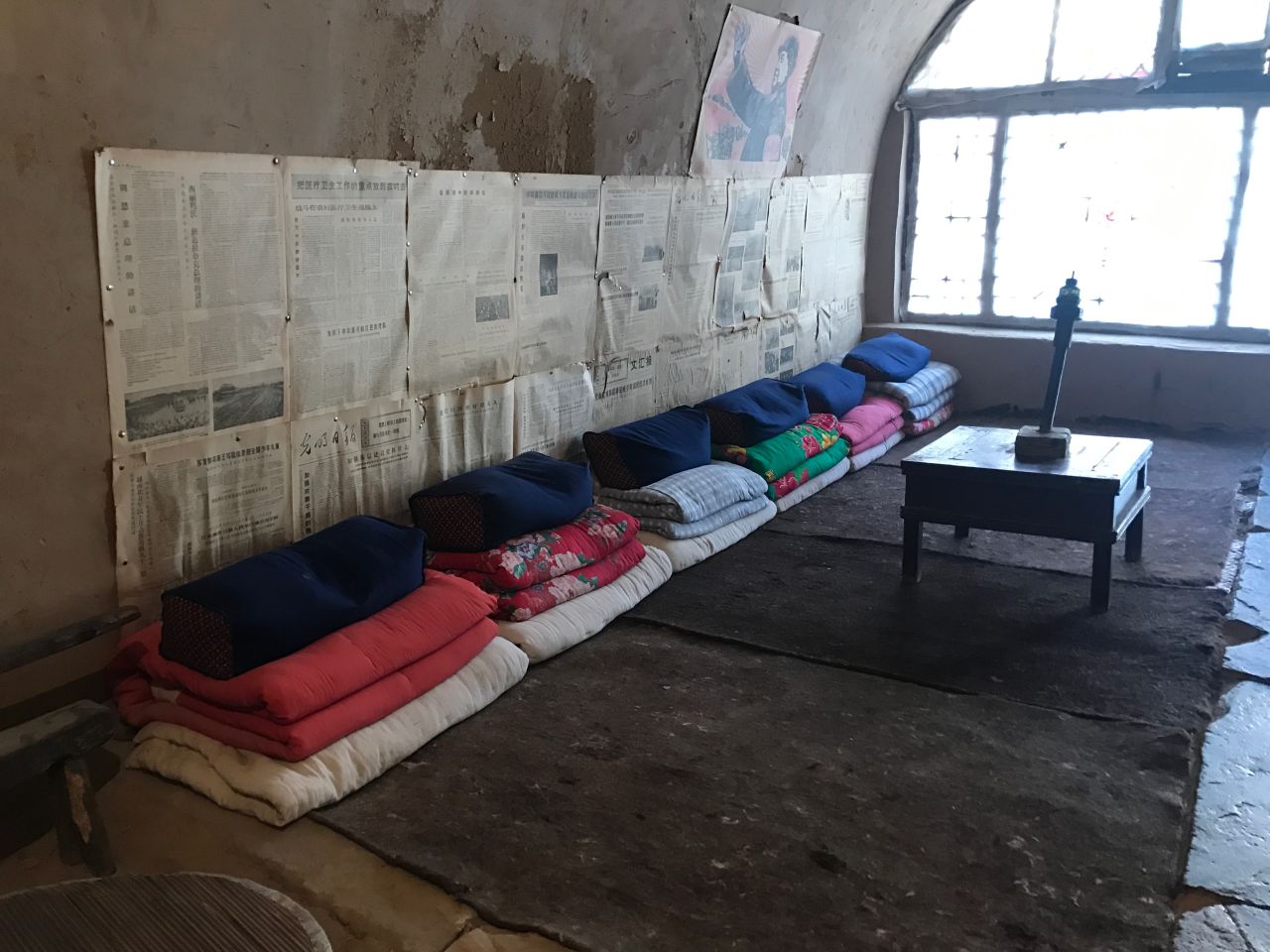 Xi's bed (shared with five others with his spot being the second from left) in his "cave house."