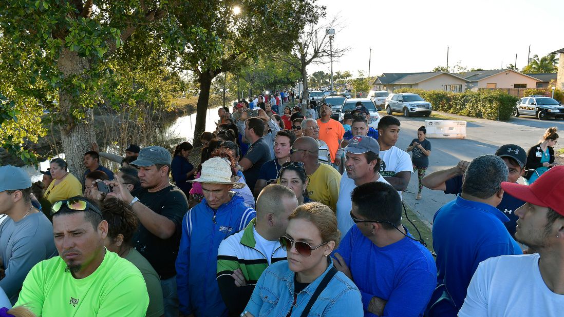 Miami residents watch rescue crews work to remove victims from the debris.