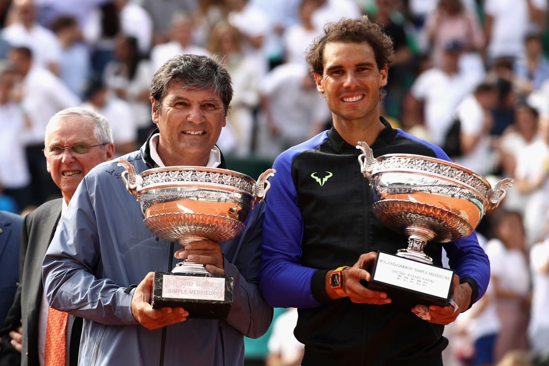 Toni Nadal (left) holds up a replica "Decima" trophy after his nephew won a 10th French Open title in 2017. 