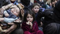 Syrian children sit while awaiting to be evacuated from the Eastern Ghouta enclave through the regime-controlled corridor opened by government forces in Hawsh al-Ashaari, east of the Eastern Ghouta enclave town of Hamouria on the outskirts of the capital Damascus on March 15, 2018.
Thousands escaped Syria's rebel-held Eastern Ghouta into government-held territory AFP correspondents on both sides said, the largest numbers since the regime assault on the enclave began. / AFP PHOTO / LOUAI BESHARA        (Photo credit should read LOUAI BESHARA/AFP/Getty Images)