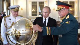 Russian President Vladimir Putin (C), Defence Minister Sergei Shoigu (R) and Commander in Chief of the Russian Navy Vladimir Korolev (L) watch a terrestrial globe while visiting Russia's Navy Headquarters during Navy Day in Saint Petersburg on July 30, 2017.
President Vladimir Putin oversaw a pomp-filled display of Russia's naval might as the Kremlin paraded its sea power from the Baltic Sea to the shores of Syria. Some 50 warships and submarines were on show along the Neva River and in the Gulf of Finland off the country's second city of Saint Petersburg after Putin ordered the navy to hold its first ever parade on such a grand scale.  / AFP PHOTO / SPUTNIK / Alexey NIKOLSKY        (Photo credit should read ALEXEY NIKOLSKY/AFP/Getty Images)
