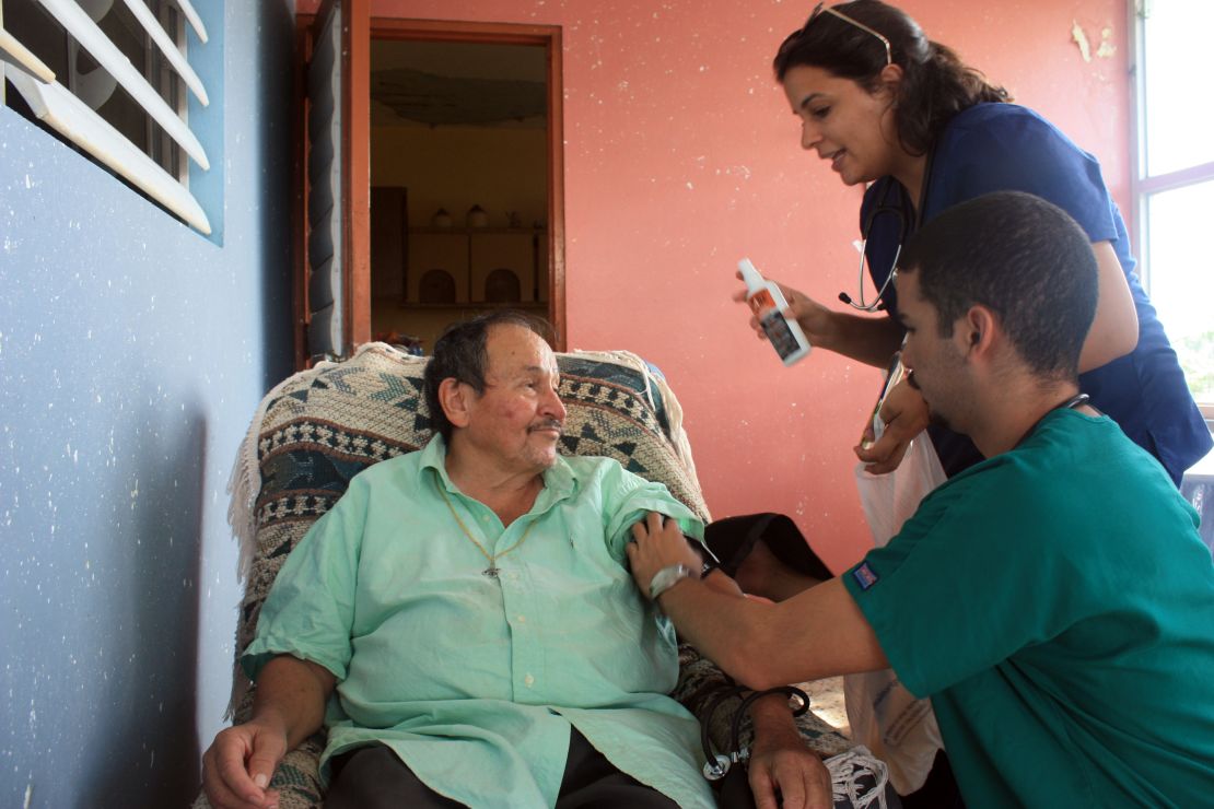 Medical students Monica Abreu and Carlos Rodriquez perform basic health checks on a Montones resident.