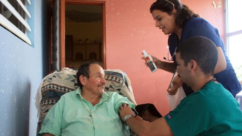 Medical students Monica Abreu and Carlos Rodriquez perform basic health checks on a Montones resident.